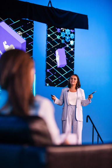 Contestant-Image-3 A contestant proposing an idea on-stage surrounded by large LED screens